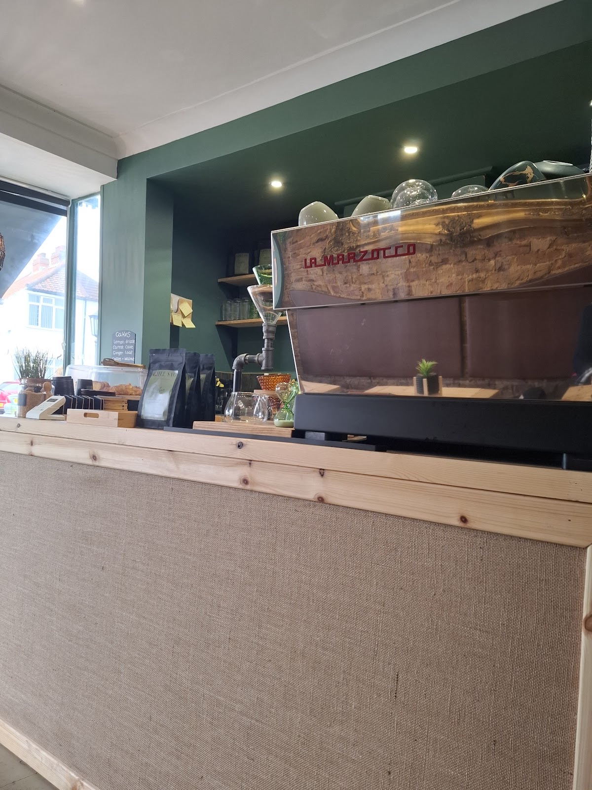 The wooden service counter with the espresso machine behind it